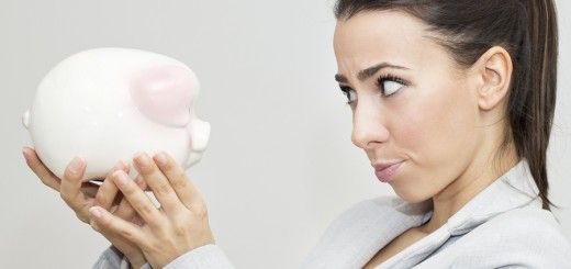 Disappointment Businesswoman Holding Piggy Bank