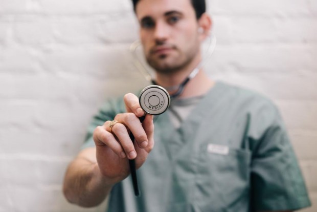 male-doctor-holding-out-stethoscope